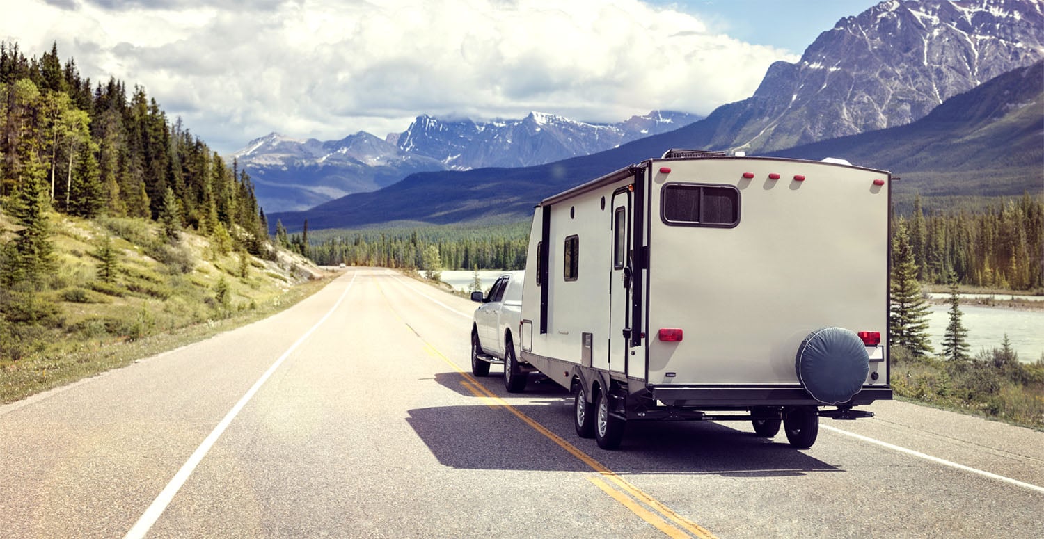 truck pulling a camper on the highway